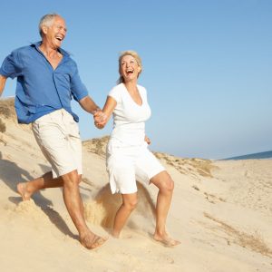 Happy older couple on the beach